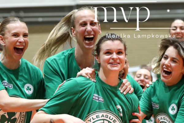 Female volleyball players in green shirts celebrate a victory, embracing on a gym court with 'Champions 2026' logos on their jerseys.
