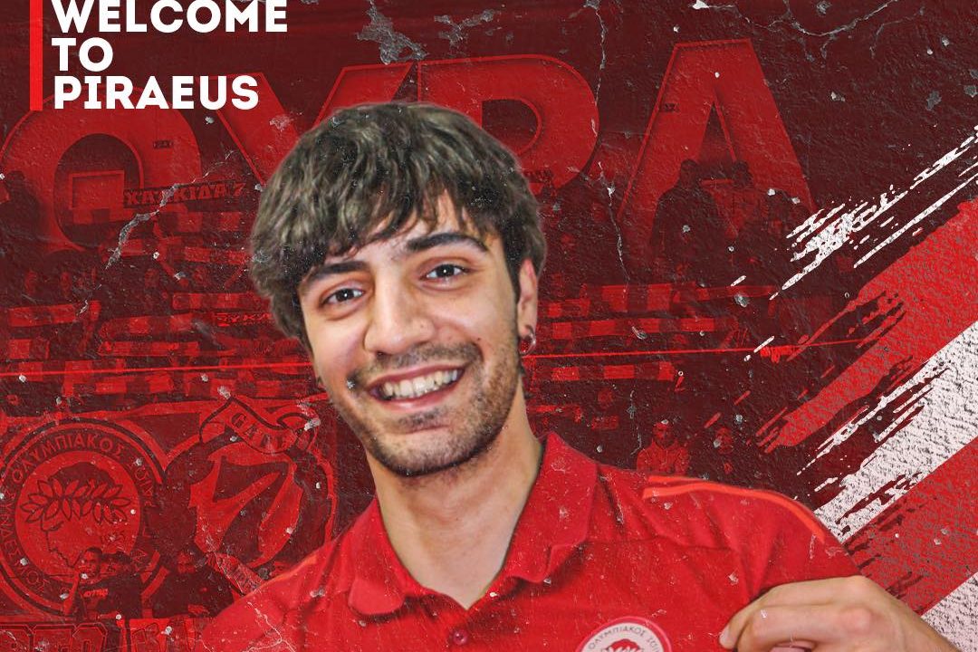 Smiling young man in a red polo shirt on a red sports poster background with Greek text and 'Olympiacos Onex Men's Volleyball Dept.'