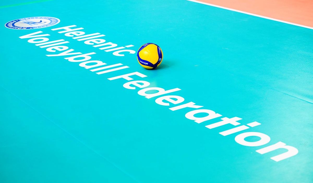 Volleyball resting on a bright turquoise court with the words 'Hellenic Volleyball Federation' and a logo in the corner.