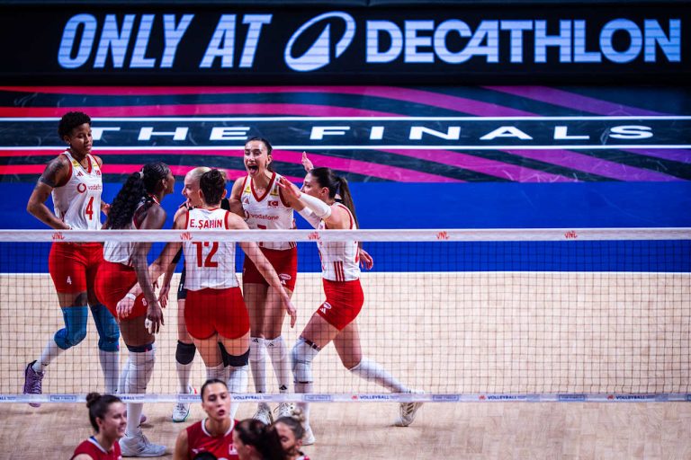 m00uo9abnscgjcaoogow The Volley Lovers Women’s volleyball team celebrates together on court during the finals, banners reading “THE FINALS” behind them.