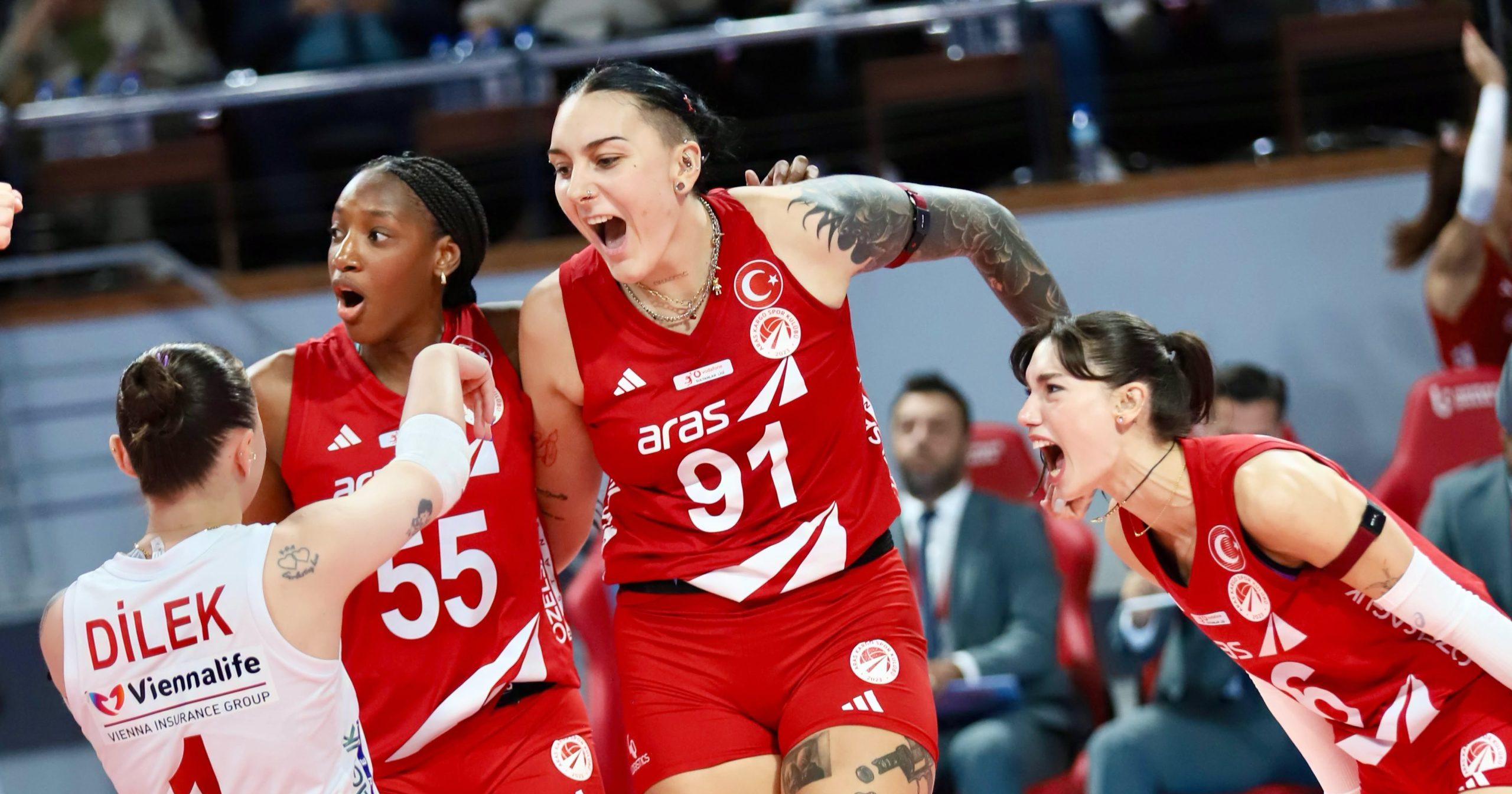 83645930910734828453114435850993270920729455n The Volley Lovers Female volleyball players in red uniforms celebrate together on court, arms raised in victory.