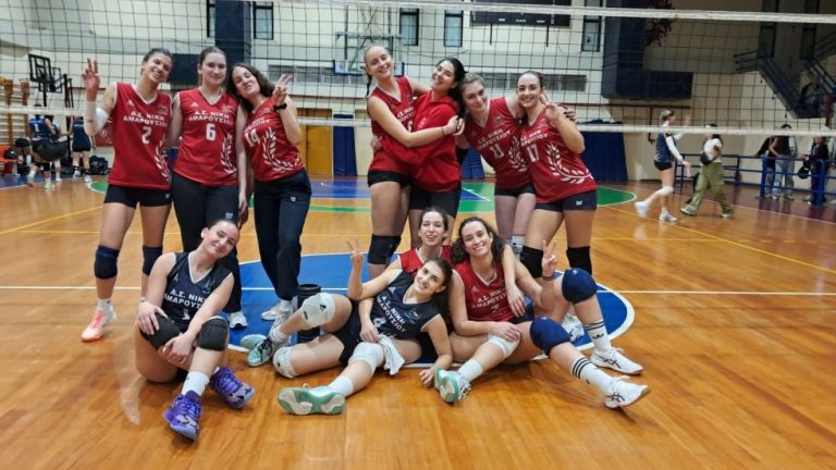 κυπελλο εσπααα γυναικες The Volley Lovers Group of young female volleyball players in red and navy jerseys posing together on an indoor court with a net in the background.